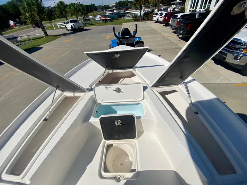 Slide: The Image of 2024 Key West 230 Bay Reef boat with open storage compartments and livewell. - 23