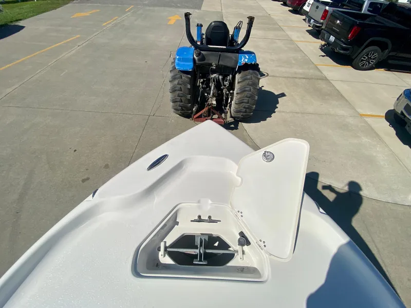 Slide: The Image of 2024 Key West 230 Bay Reef boat being towed by a blue tractor. - 30