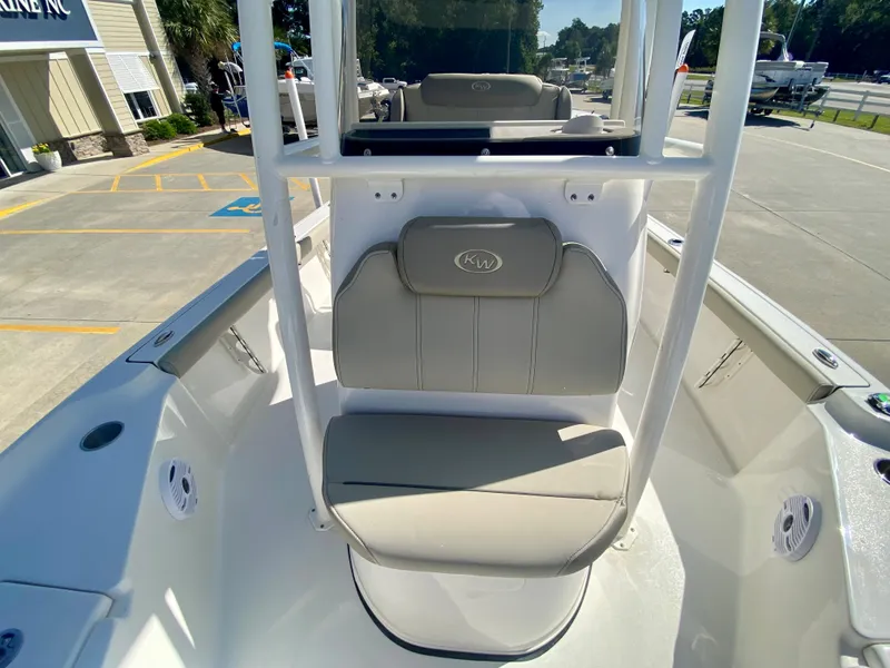 Slide: The Image of 2024 Key West 230 Bay Reef boat interior with cushioned seating and console. - 20