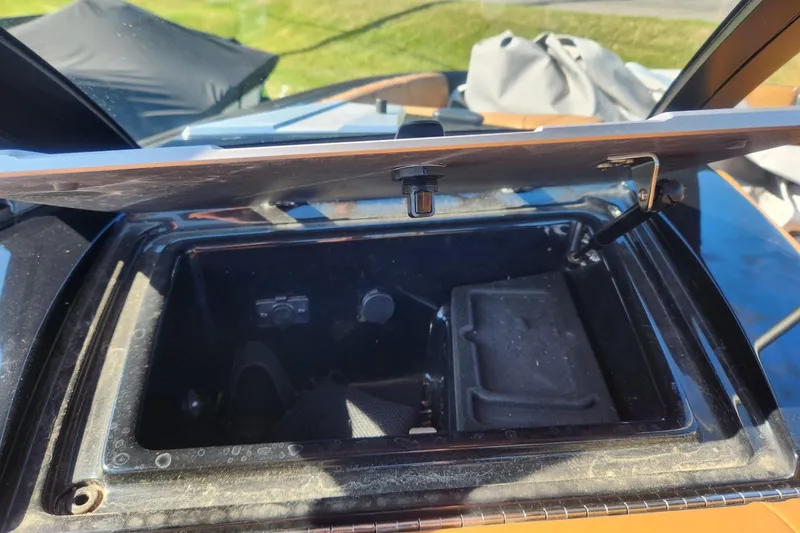 Slide: The Image of Open storage compartment in 2021 Malibu Wakesetter 24 MXZ boat. - 17