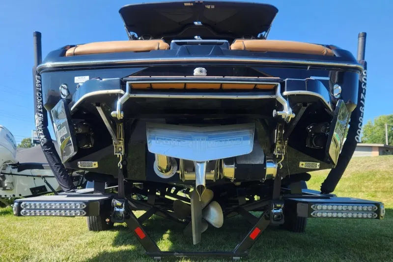 Slide: The Image of 2021 Malibu Wakesetter 24 MXZ boat rear view with propeller and trim tabs. - 20