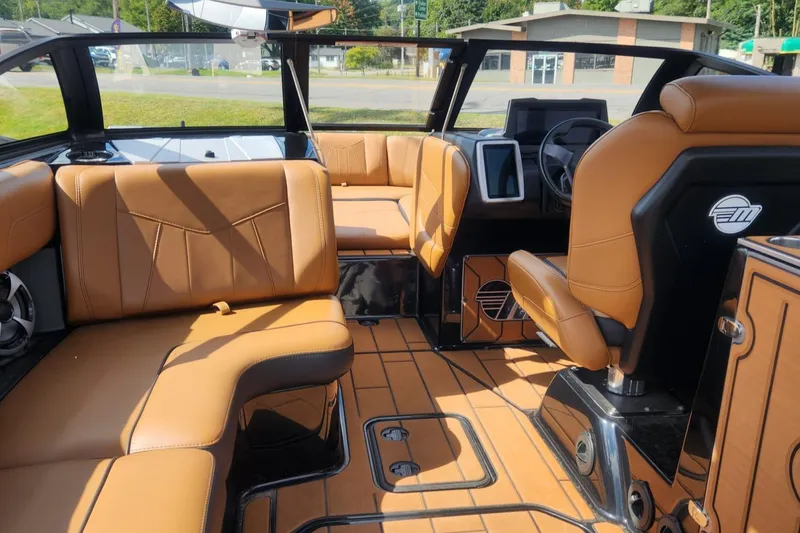 Slide: The Image of Luxurious interior of 2021 Malibu Wakesetter 24 MXZ boat with tan leather seating. - 23