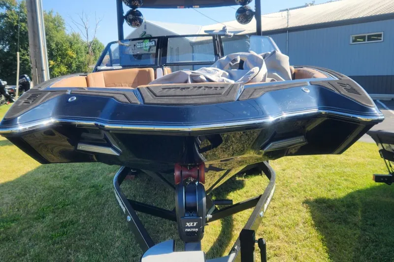 Slide: The Image of 2021 Malibu Wakesetter 24 MXZ boat on trailer, parked on grass. - 4