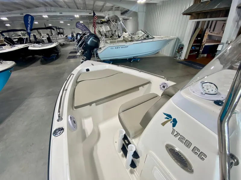 Slide: The Image of 2024 Key West 1720 CC boat in showroom, front seating area view. - 12