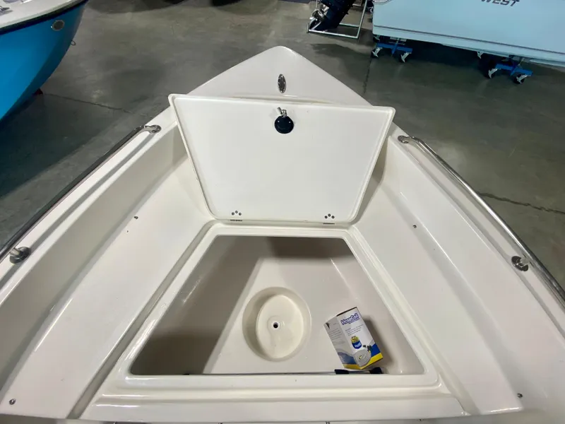 Slide: The Image of 2024 Key West 1720 CC boat bow storage compartment with open hatch. - 16