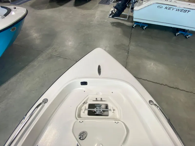 Slide: The Image of 2024 Key West 1720 CC boat bow with anchor storage in showroom. - 17