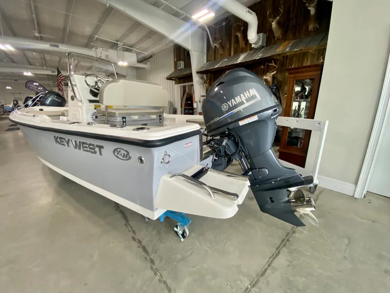 Slide: The Image of 2024 Key West 1720 CC boat with Yamaha outboard motor in showroom. - 2