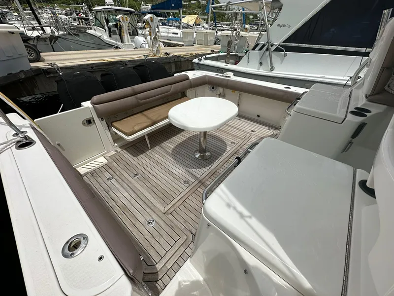 Slide: The Image of 2010 Boston Whaler 345 Conquest boat deck with seating and table. - 12