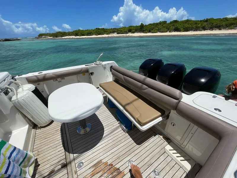 Slide: The Image of Boston Whaler 345 Conquest 2010 boat interior with ocean view and seating area. - 16