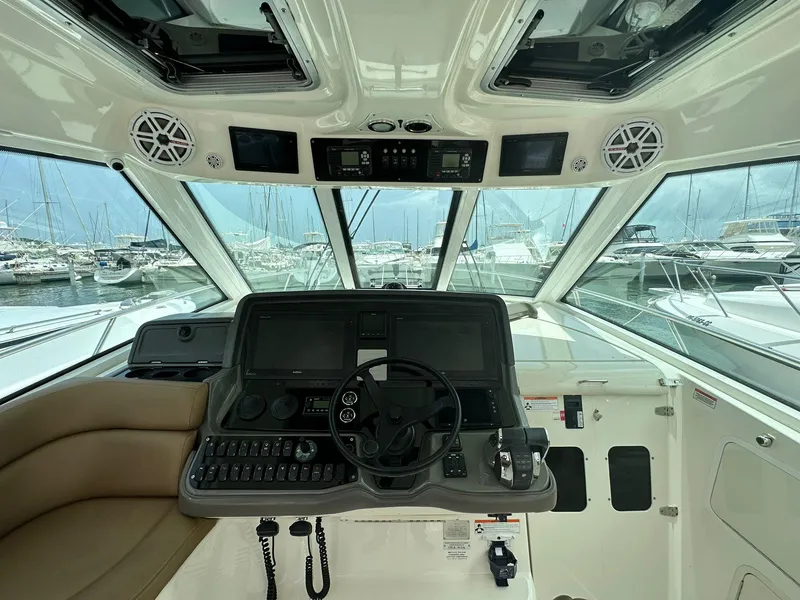 Slide: The Image of Helm of 2010 Boston Whaler 345 Conquest with marina view. - 2