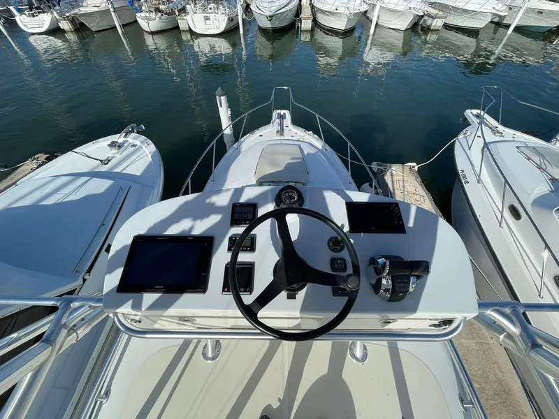 Slide: The Image of Helm of 2010 Boston Whaler 345 Conquest with navigation equipment, docked at marina. - 4