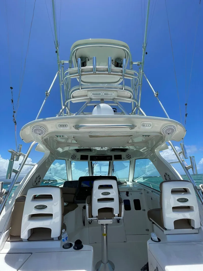 Slide: The Image of 2010 Boston Whaler 345 Conquest boat with tower against clear blue sky. - 5