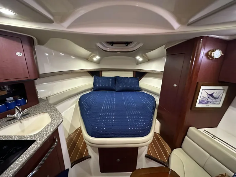 Slide: The Image of Luxurious cabin interior of 2010 Boston Whaler 345 Conquest with cozy bed and kitchenette. - 9