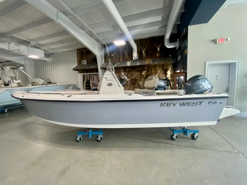 Slide: The Image of 2024 Key West 1720 CC boat displayed in an indoor showroom. - 3