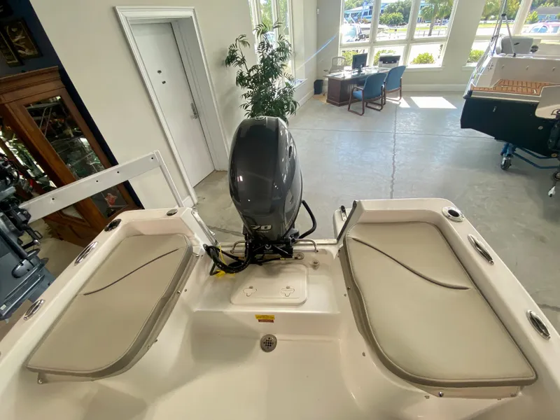 Slide: The Image of 2024 Key West 1720 CC boat interior with motor, showroom display. - 5