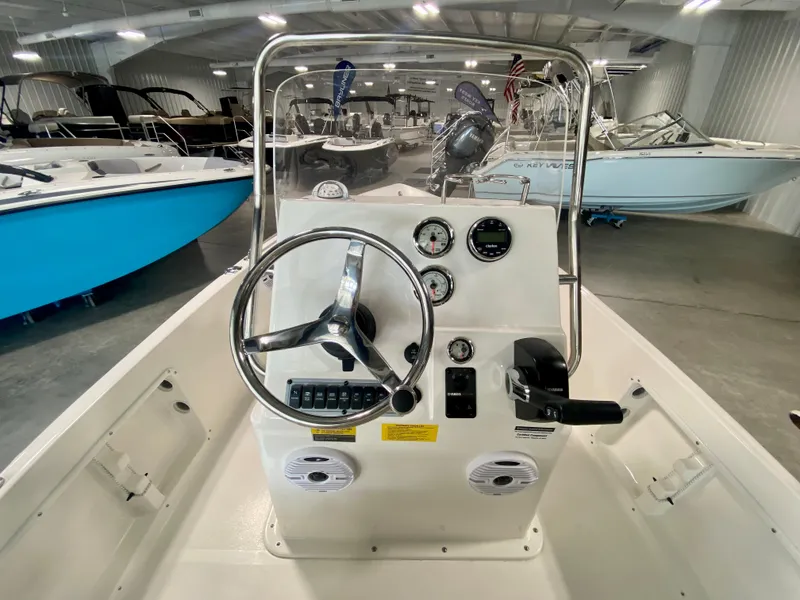 Slide: The Image of 2024 Key West 1720 CC center console boat interior with steering wheel and gauges. - 9