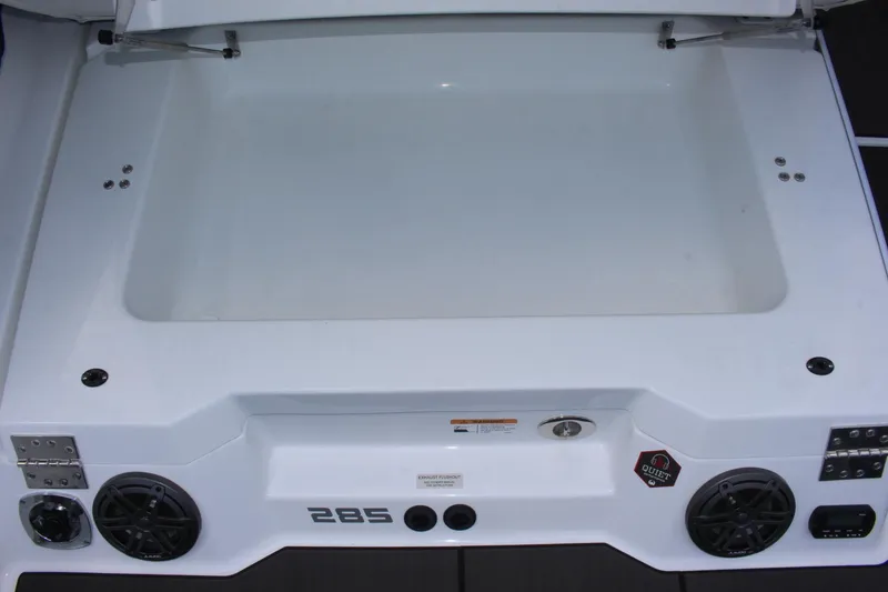 Slide: The Image of 2023 Scarab 285 ID boat storage compartment with speakers and control panel. - 17