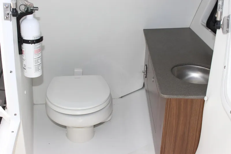 Slide: The Image of 2023 Scarab 285 ID boat bathroom with toilet, sink, and fire extinguisher. - 19
