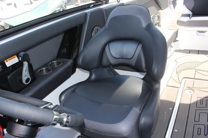 Slide: The Image of 2023 Scarab 285 ID boat captain's seat and control panel. - 8