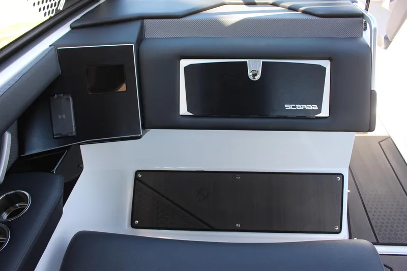 Slide: The Image of 2023 Scarab 285 ID boat interior dashboard with storage compartments. - 9