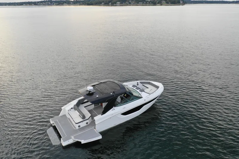 Slide: The Image of 2022 Cruisers Yachts 38 GLS on calm water, showcasing sleek design and spacious deck. - 3