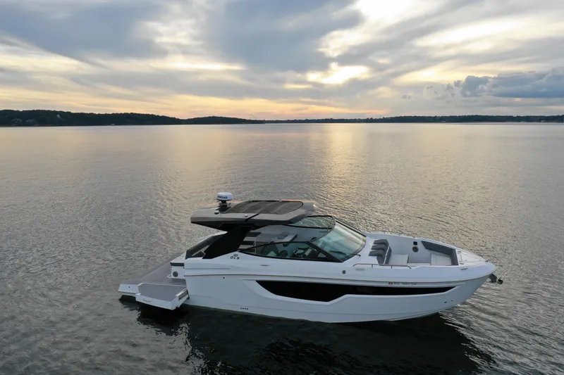 Slide: The Image of 2022 Cruisers Yachts 38 GLS on serene water at sunset. - 5