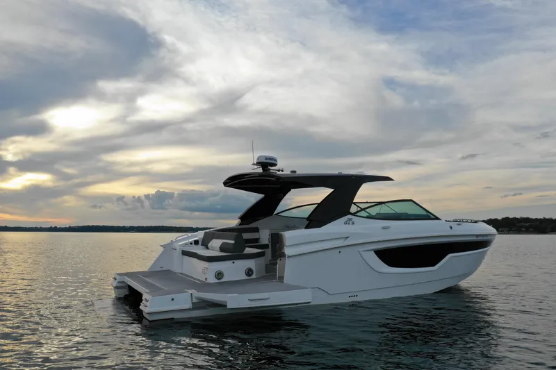 Slide: The Image of 2022 Cruisers Yachts 38 GLS on calm water at sunset. - 6