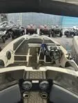 Slide: The Image of 2023 Scarab 165 ID boat interior at a dealership. - 5