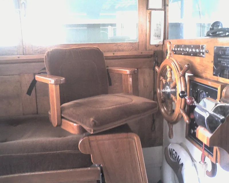 Slide: The Image of 1930 Blanchard Lake Union Dreamboat helm with vintage wooden steering wheel and captain's chair. - 11