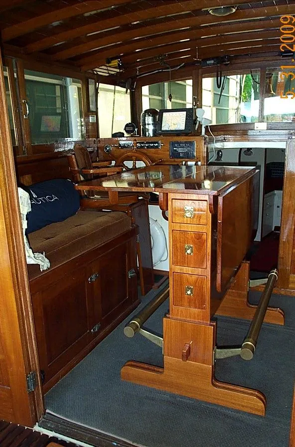 Slide: The Image of 1930 Blanchard Lake Union Dreamboat interior with vintage wooden furnishings and navigation equipment. - 12