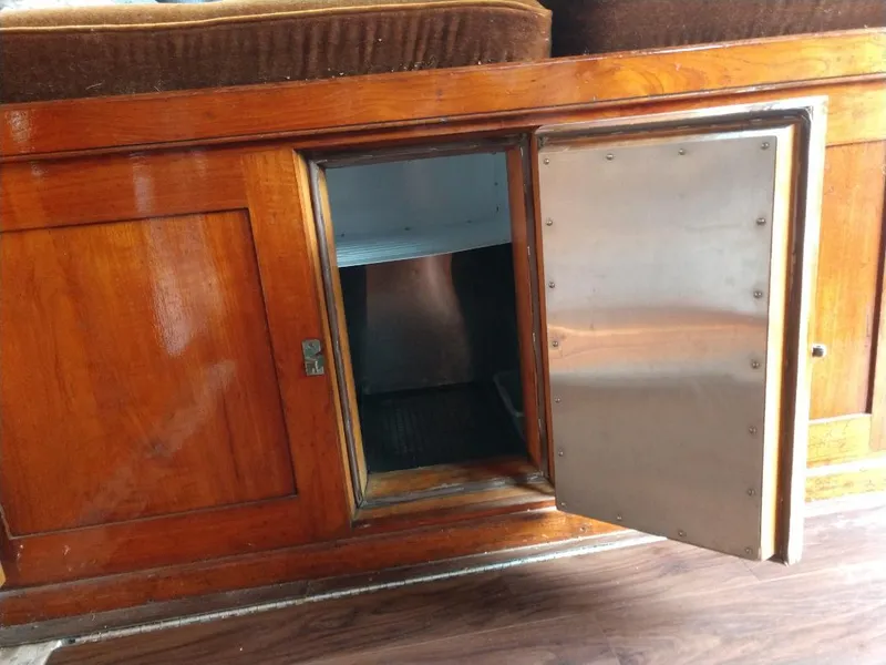 Slide: The Image of Wooden cabinet with open metal door on 1930 Blanchard Lake Union Dreamboat. - 19