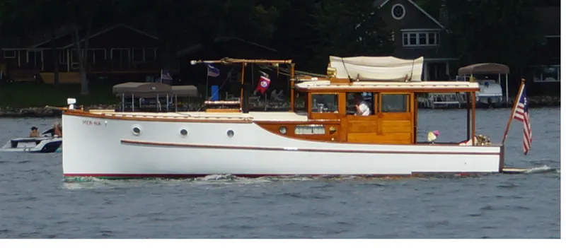 Slide: The Image of 1930 Blanchard Lake Union Dreamboat cruising on a lake with scenic background. - 4