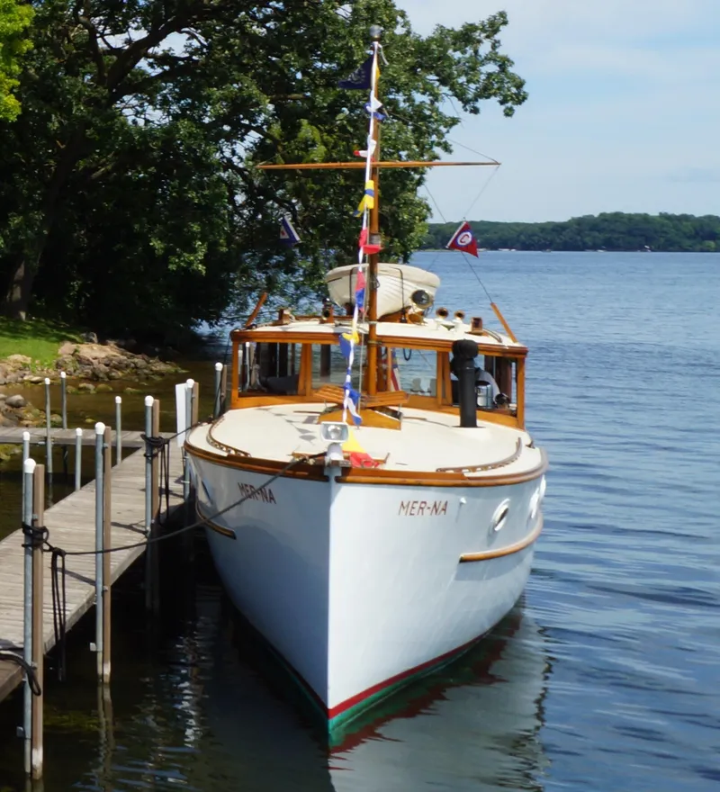 Slide: The Image of 1930 Blanchard Lake Union Dreamboat docked by a serene lakeside. - 7