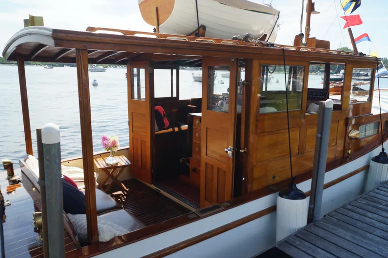 Slide: The Image of 1930 Blanchard Lake Union Dreamboat with wooden cabin, docked by the water. - 8