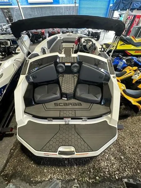 Slide: The Image of 2023 Scarab 165 ID jet boat with black seats and modern interior design. - 4