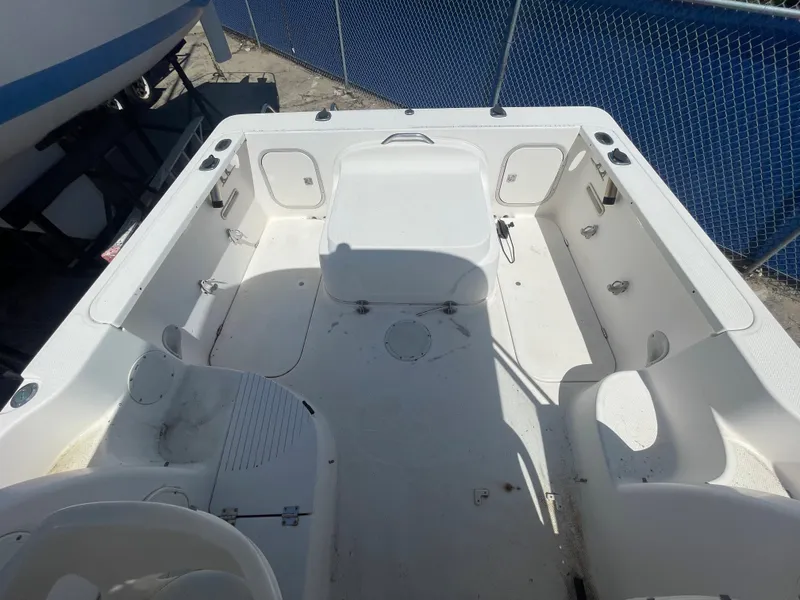 Slide: The Image of 2003 Trophy 2052 Walkaround boat interior, spacious deck with seating and storage compartments. - 11