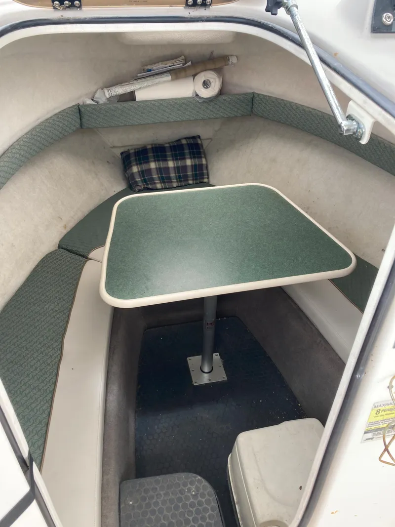 Slide: The Image of 2003 Trophy 2052 Walkaround cabin interior with table and seating. - 13