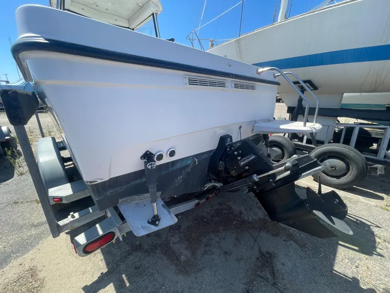 Slide: The Image of 2003 Trophy 2052 Walkaround boat rear view with outboard motor on trailer. - 2