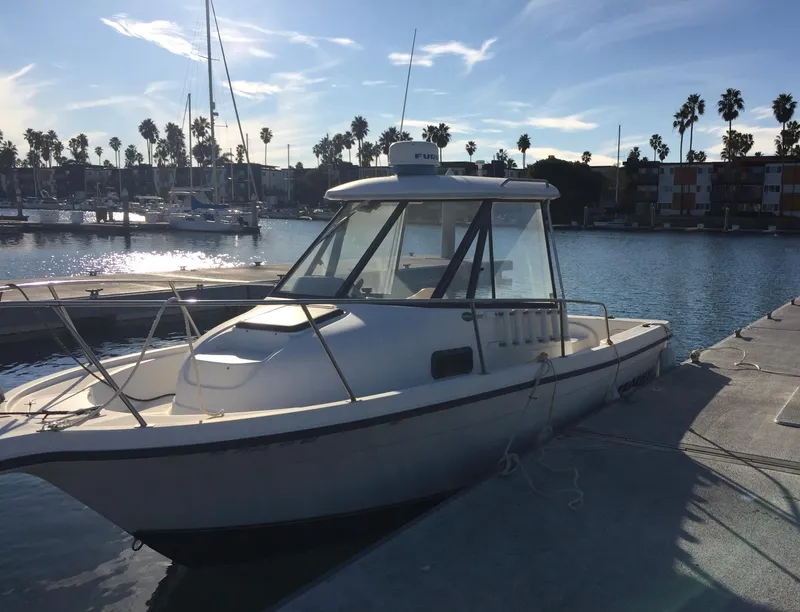 Slide: The Image of 2003 Trophy 2052 Walkaround boat docked at a marina on a sunny day. - 3