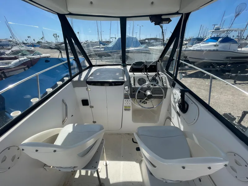 Slide: The Image of 2003 Trophy 2052 Walkaround boat cockpit with steering wheel and seating. - 8