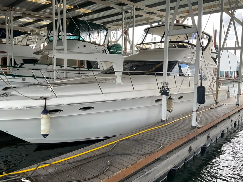 The Image of 1999 Sea Ray 560 Sedan Bridge yacht docked in a covered marina. - 0