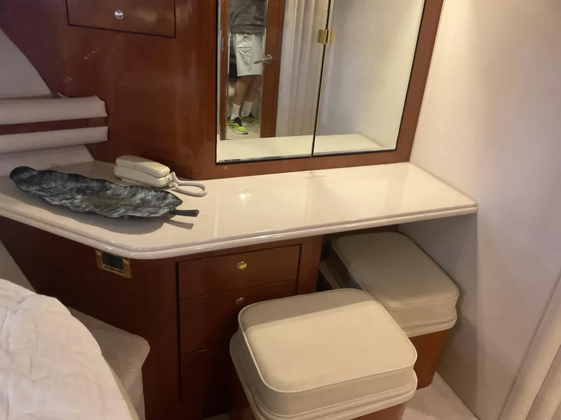 Slide: The Image of 1999 Sea Ray 560 Sedan Bridge cabin with vanity, mirror, and storage. - 13
