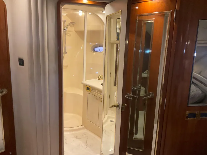 Slide: The Image of 1999 Sea Ray 560 Sedan Bridge yacht interior with elegant bathroom and wooden finishes. - 15