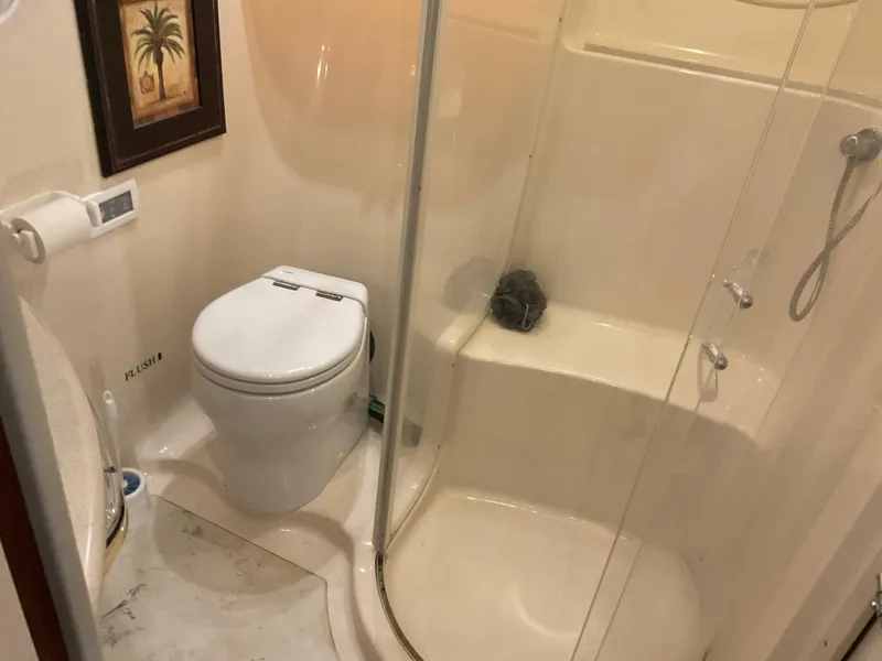 Slide: The Image of Bathroom interior of 1999 Sea Ray 560 Sedan Bridge yacht with shower and toilet. - 16