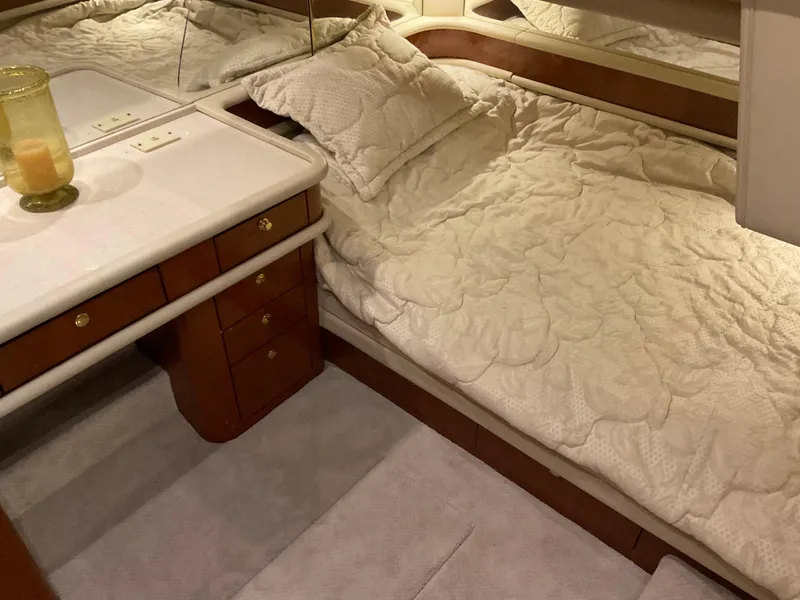 Slide: The Image of Luxurious cabin interior of 1999 Sea Ray 560 Sedan Bridge yacht with elegant bedding. - 17