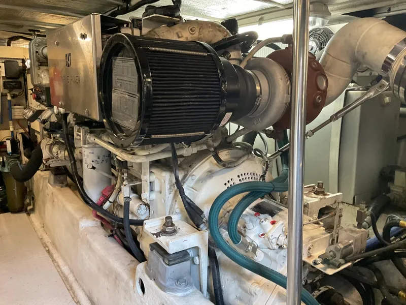 Slide: The Image of Engine room of a 1999 Sea Ray 560 Sedan Bridge yacht, showcasing mechanical components. - 24