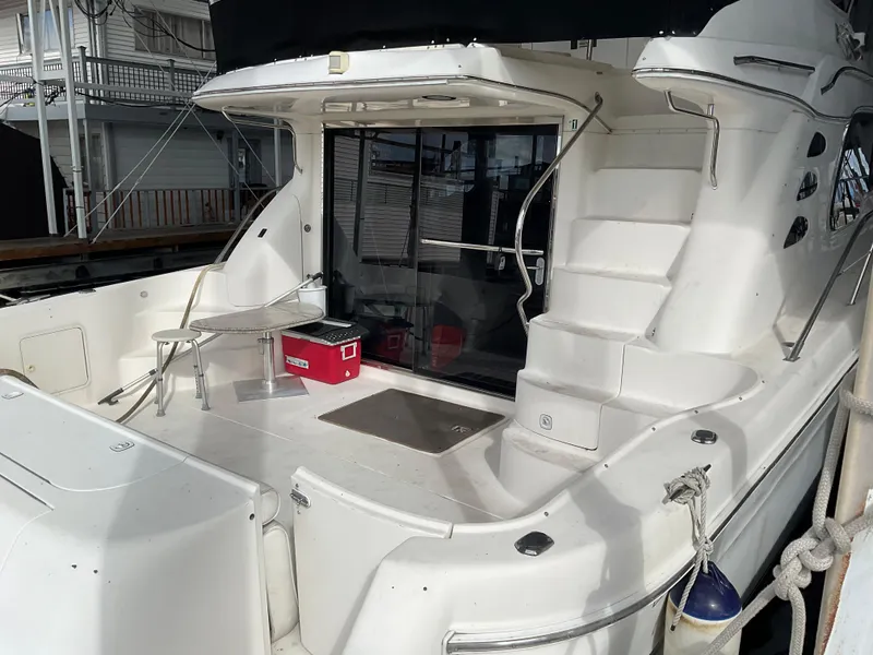 Slide: The Image of 1999 Sea Ray 560 Sedan Bridge yacht with spacious deck and modern design. - 3