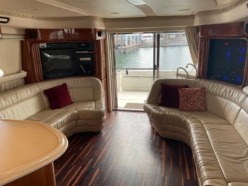 Slide: The Image of Luxurious interior of a 1999 Sea Ray 560 Sedan Bridge yacht with leather seating and wood flooring. - 4