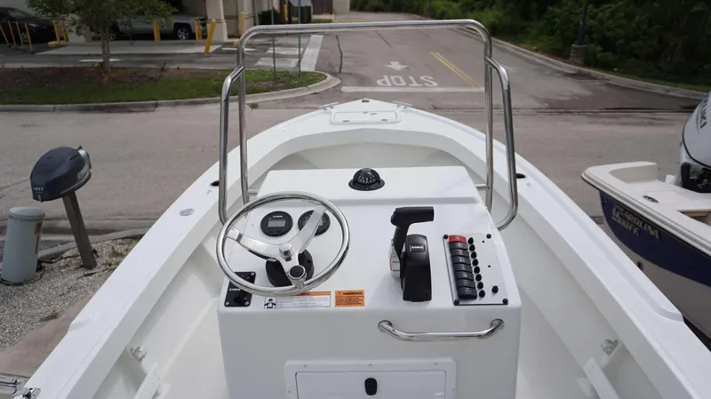 Slide: The Image of 2024 Parker 1801 CS boat console with steering wheel, controls, and navigation instruments. - 3