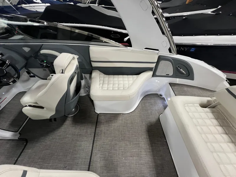 Slide: The Image of 2018 Cobalt R5 boat interior with white leather seating and modern dashboard. - 10